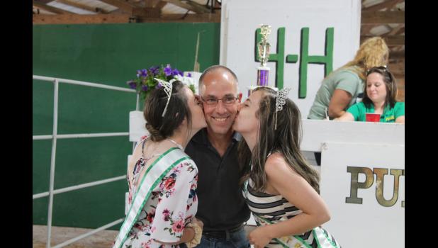 It was double the trouble for Brian Cords who bought the kisses of his daughters, 2020 4-H Royalty Queen Jenna Cords and 2021 4-H Royalty Queen Jaden Cords.