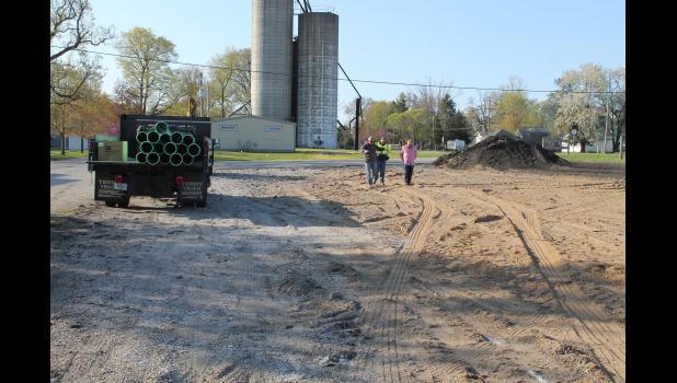FORM-IT CORP owner Glen White talks with Winamac Street and Water Superintendent Jeremy Beckner and town manager Brad Zellers before he begins constructing the Owen Abbott Memorial Splash Pad shelter on Monday.
