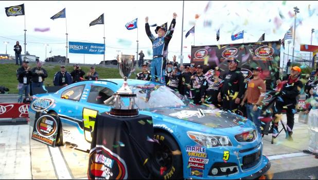 Winamac’s Justin Haley climbs from his car at Dover’s Monster Mile amidst confetti and cheers after securing the championship in the NASCAR K&N Pro Series East Friday, Sept. 30.