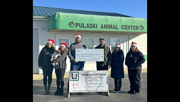 Pulaski County Journal sales manager Andrew Van Auken presented the check to PAC's manager Ryan Robinson along with Journal staff: Tracey Collins (circulation), Frankie (the French boss), Kari Stout (managing editor), Megan Galbreath (news editor) and Kara Beavers (graphic design).