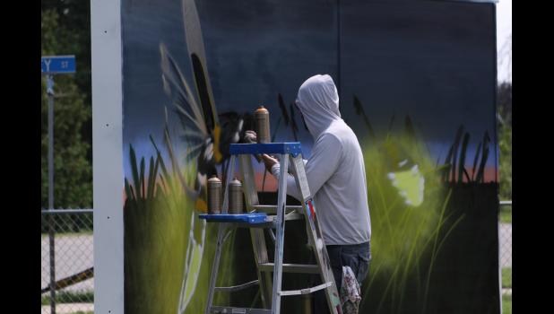 Photo by Paul Hettinger Indiana artist Zach Medler worked throughout the day on the winning design.