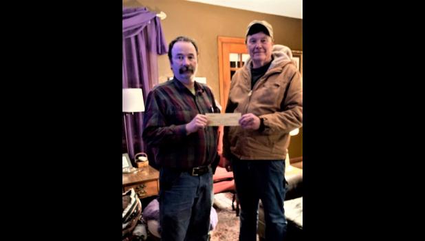 Photo Provided. Monterey Lions Club President Doug Denton (right) presented Monterey Fire Department Chief Doug Klausing (left) with a check for $225 to go toward new radios.