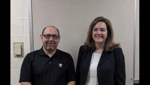 Dr. Cathy Rowe (right) is shown with school board president Kyle McTeigue.