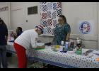 Carolyn Blaker enters into a drawing for a pot of flowers at the Pulaski Health Care Center booth. She later won.