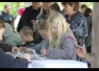 Kids get started on their watercolor snail creations after receiving guidance from Lynn Darda.