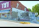 The fence surrounding the Sportsman’s Bar and Grill is beginning to block the sidewalk and could soon be in the street. Commissioners discussed the issue on Monday because the fence belongs to the county.